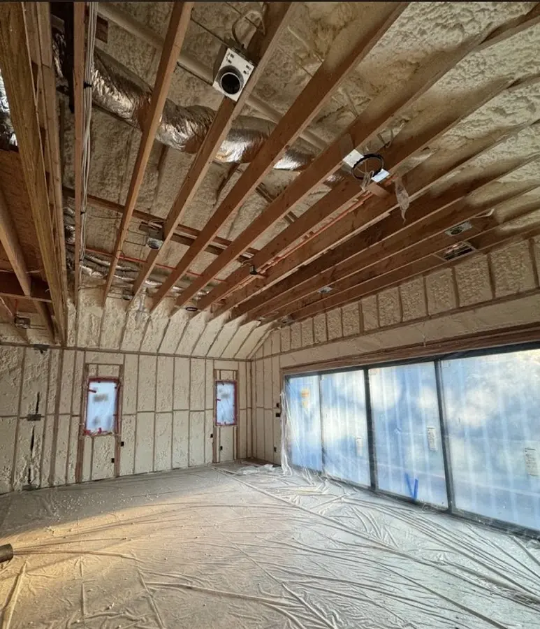 Interior walls and ceiling insulated with spray foam during new construction in Brazil